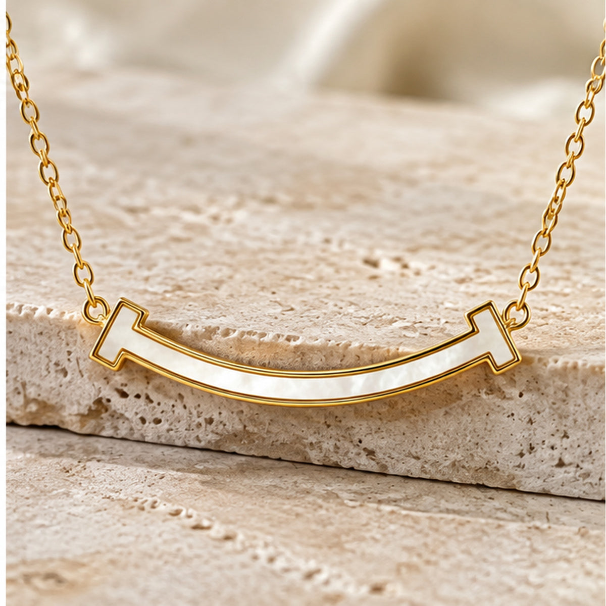 Curved mother of pearl bar necklace in gold styled on neutral stone