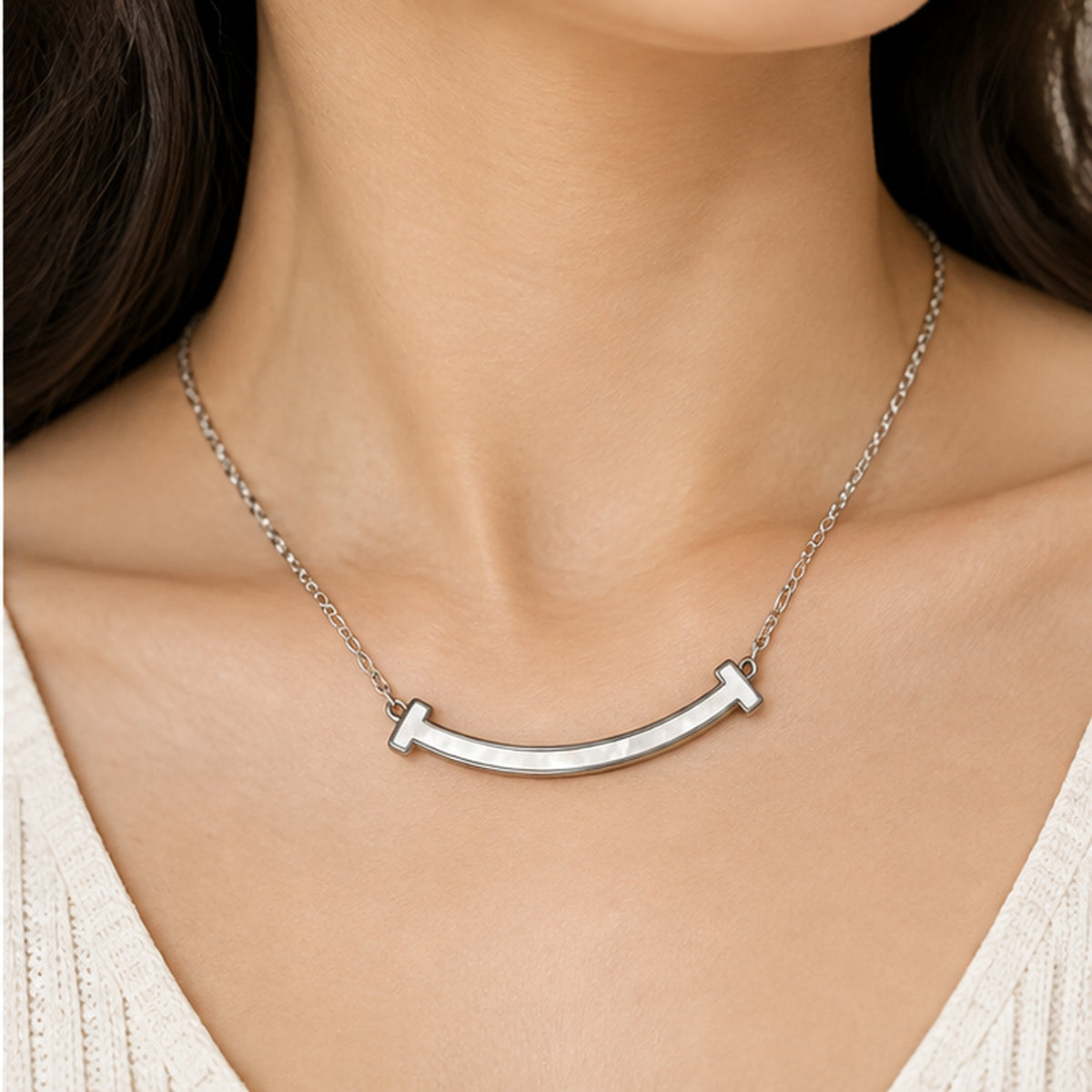Curved mother of pearl bar necklace in silver worn on the neck