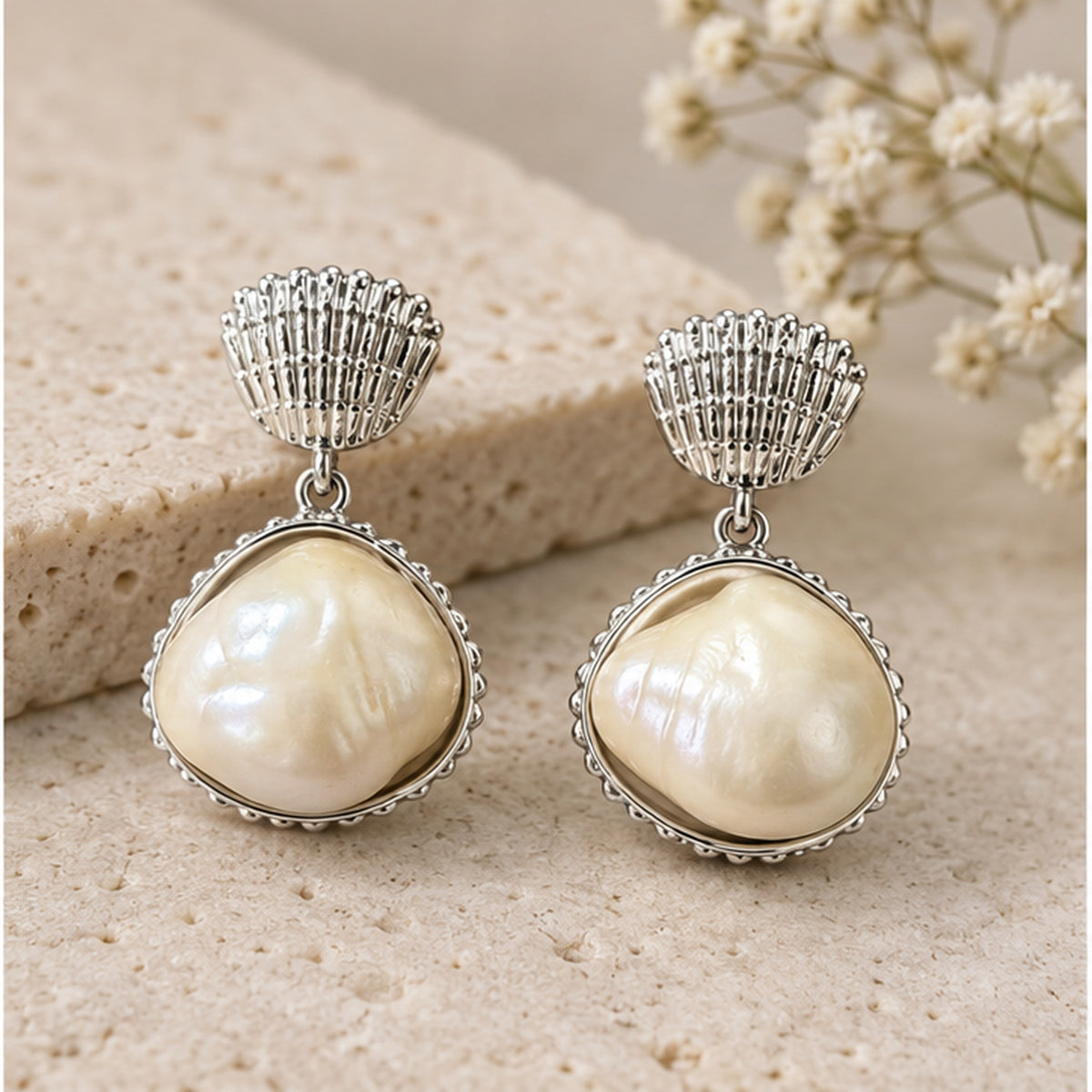 NZGO Pearl baroque real pearl shell drop earrings in a neutral studio setting