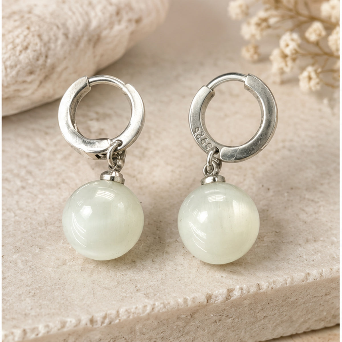 NZGO Pearl Cat's Eye bead sterling silver hoop earrings in a neutral studio setting
