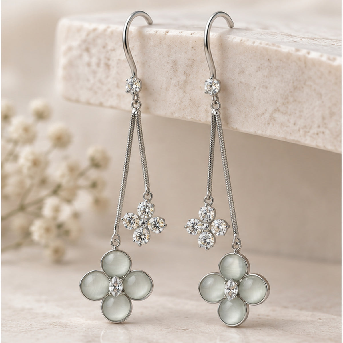 NZGO Pearl Cat's Eye floral drop earrings in a neutral studio setting