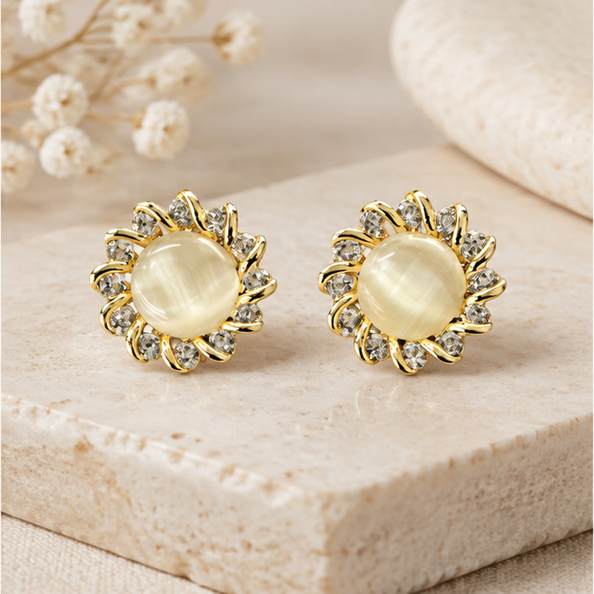 NZGO Pearl Cat's Eye sunburst stud earrings in a neutral studio setting