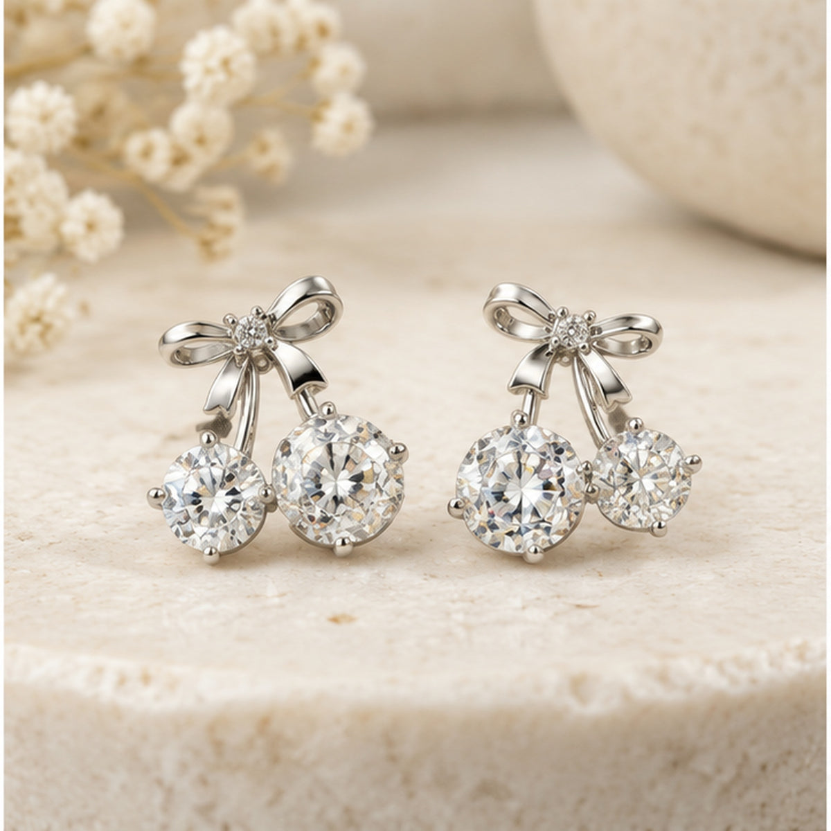 NZGO Pearl clear stone bow double drop stud earrings in a neutral studio setting