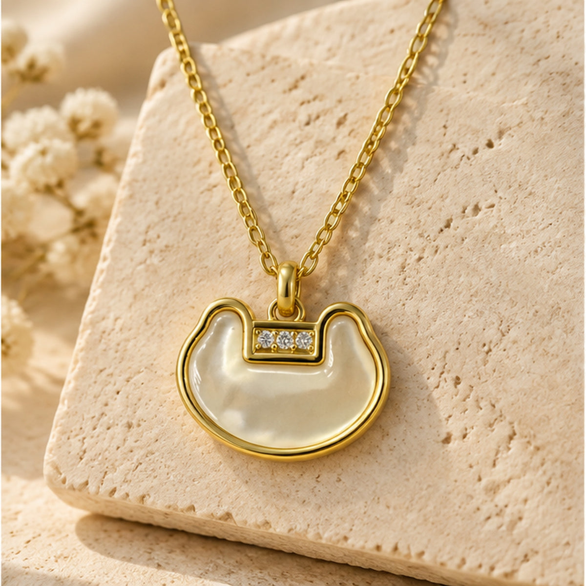 NZGO Pearl open crescent crystal pendant necklace in a neutral studio setting