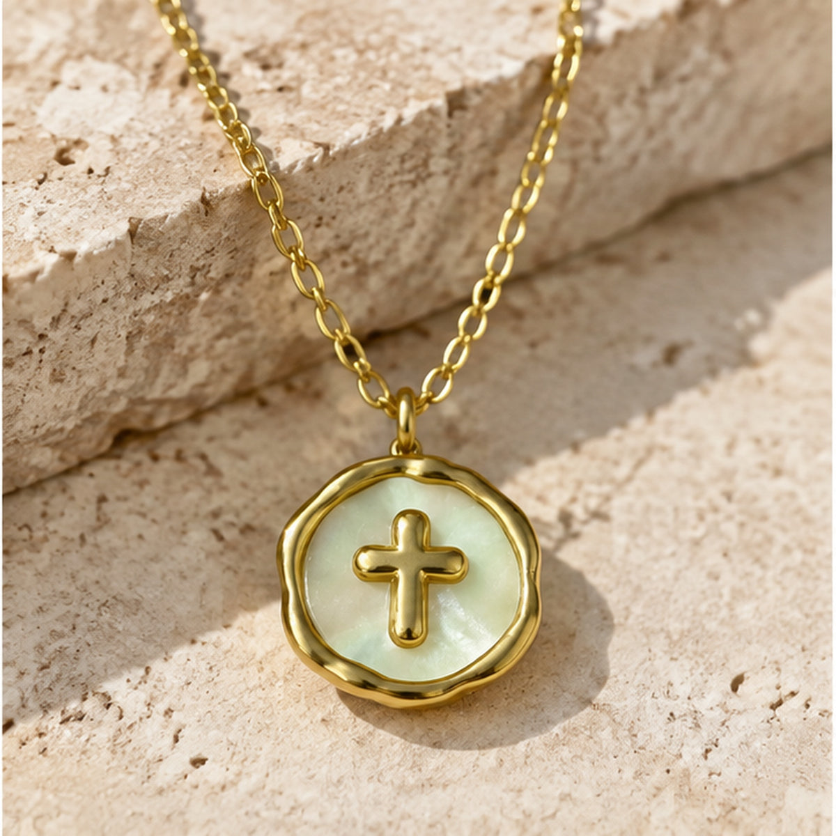 NZGO Pearl cross medallion pendant necklace in a neutral studio setting
