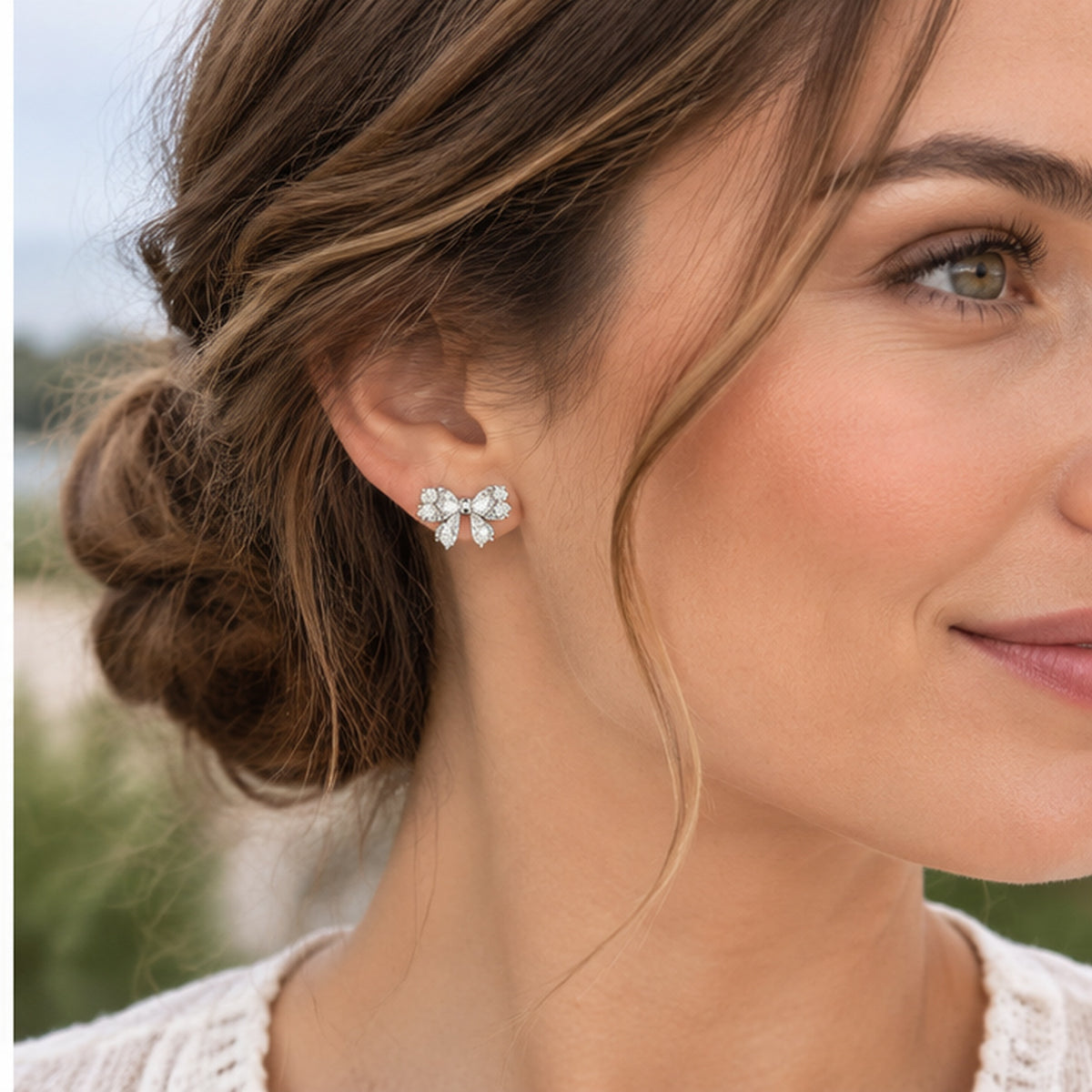 NZGO Pearl crystal bow stud earrings worn at realistic scale