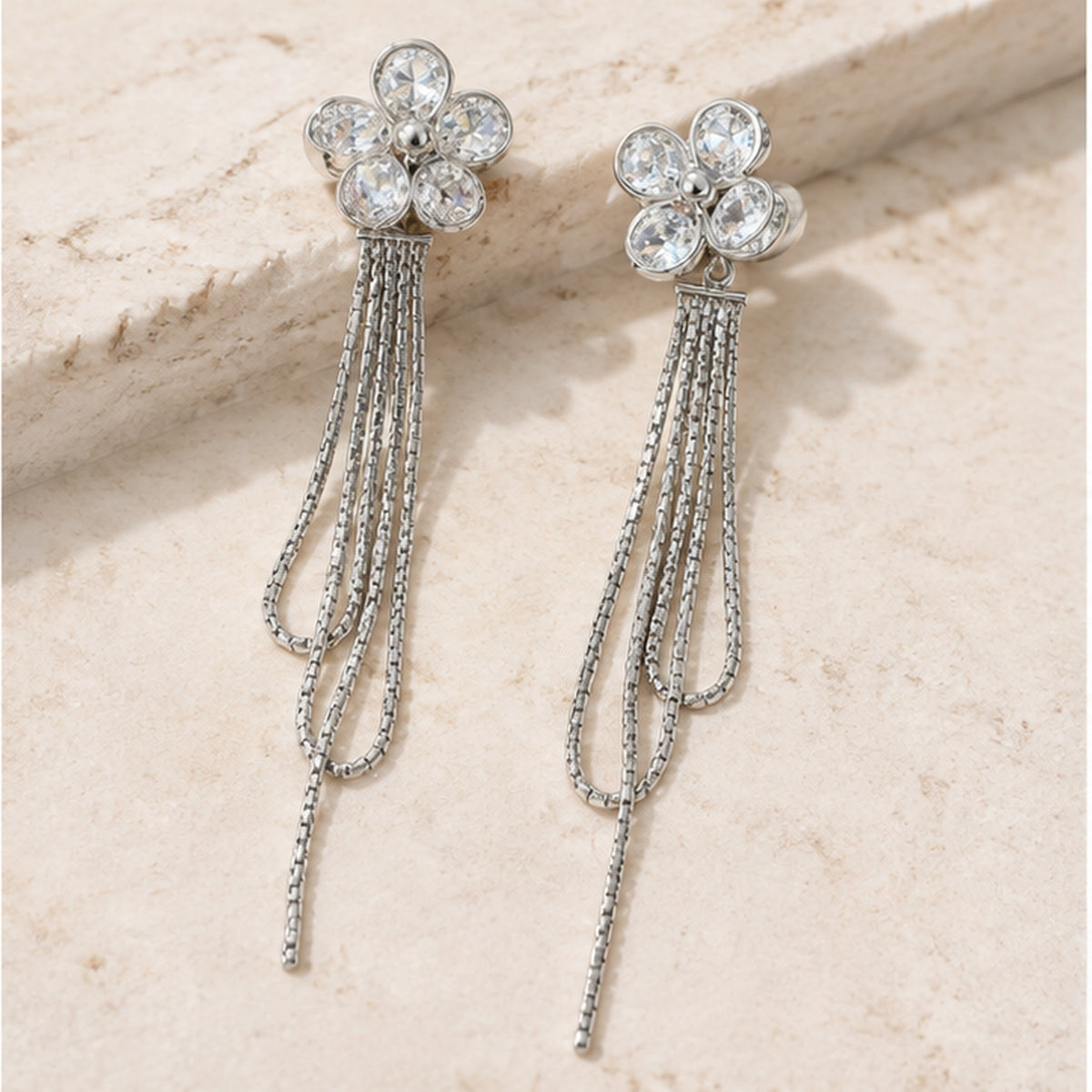 NZGO Pearl crystal flower chain tassel earrings in a neutral studio setting