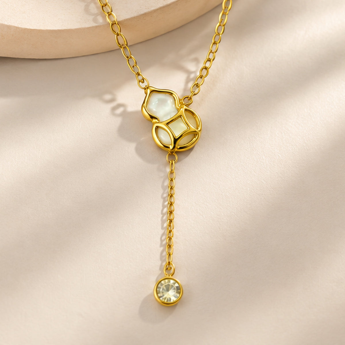 NZGO Pearl geometric crystal drop Y necklace in a neutral studio setting