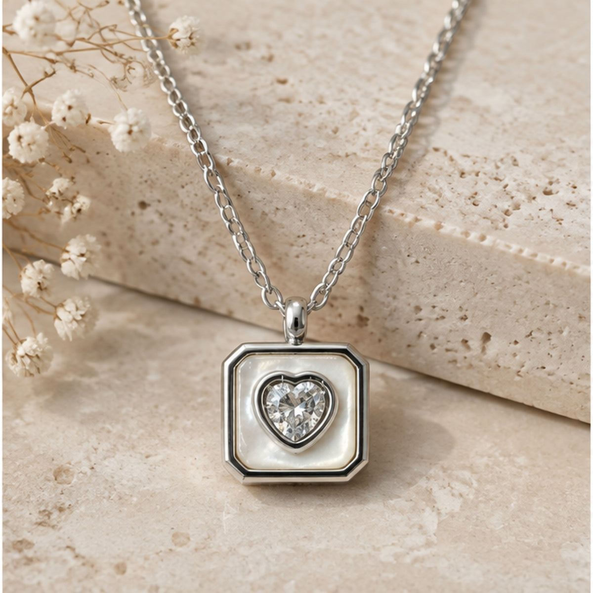 NZGO Pearl heart crystal square pendant necklace in a neutral studio setting