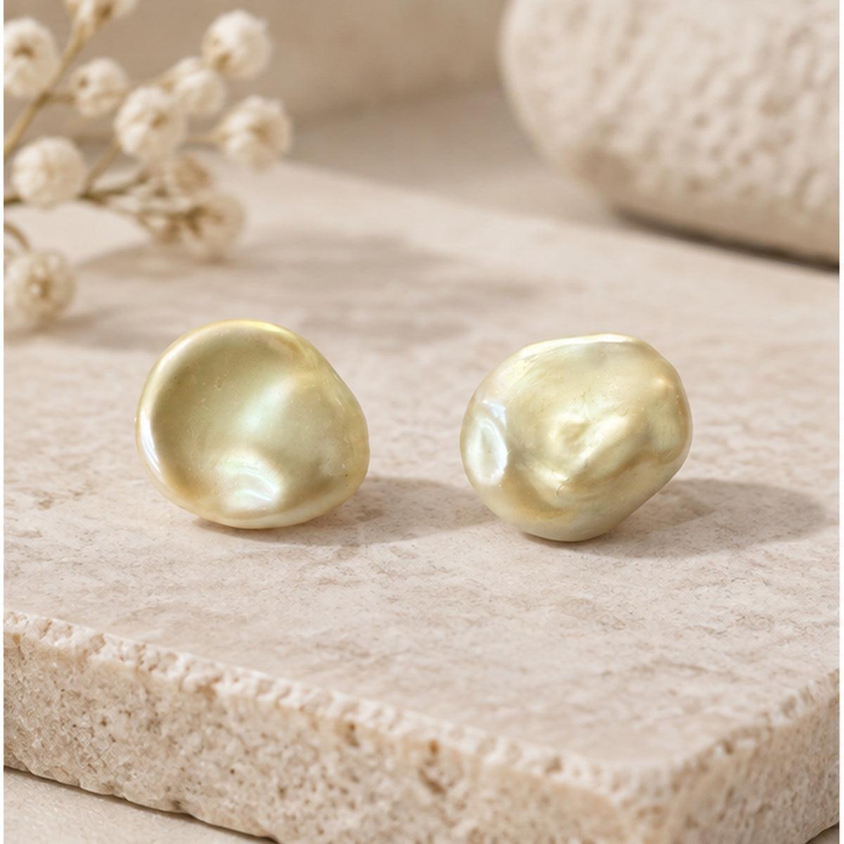 NZGO Pearl lock and key style real pearl stud earrings styled on neutral stone