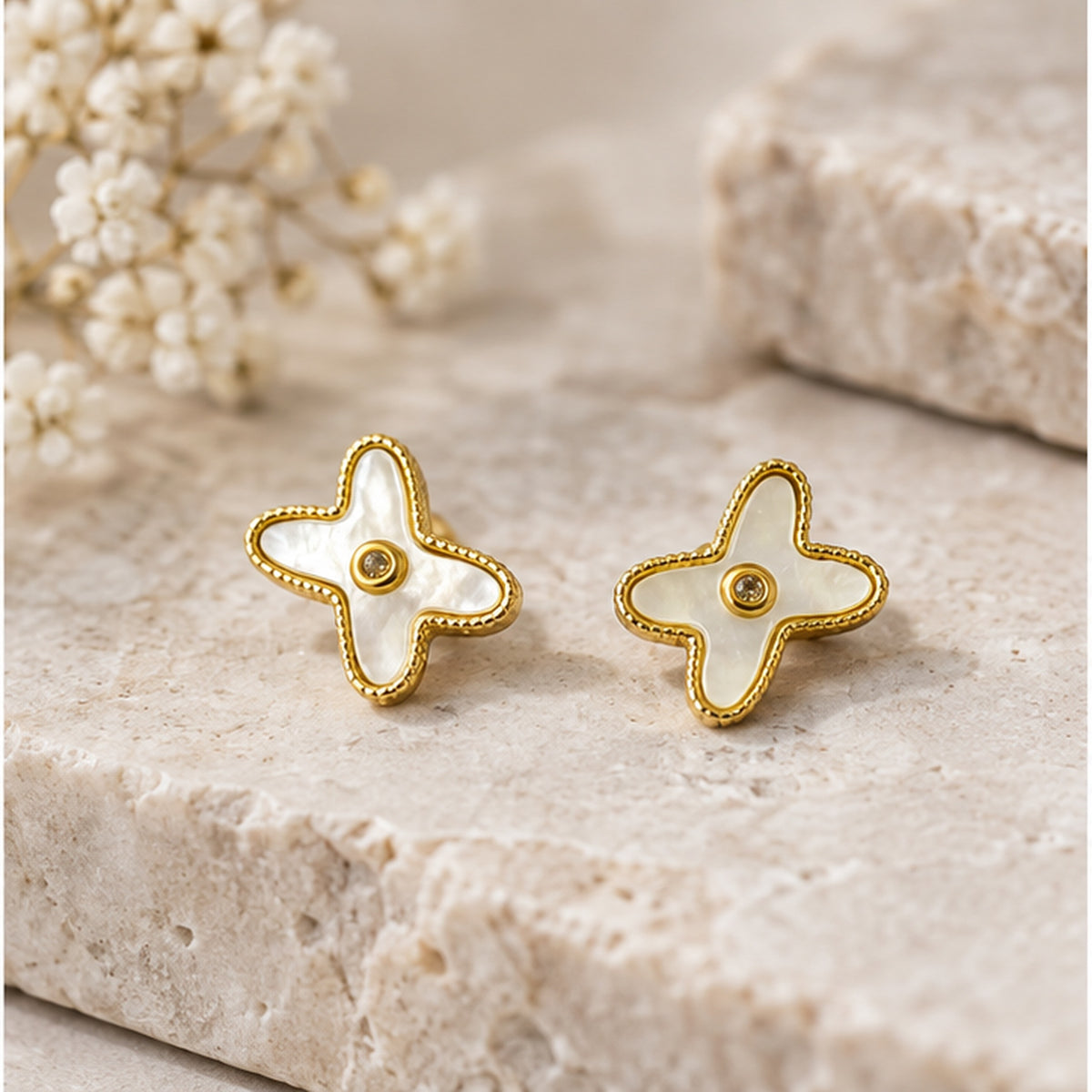NZGO Pearl real mother of pearl clover stud earrings styled on neutral stone