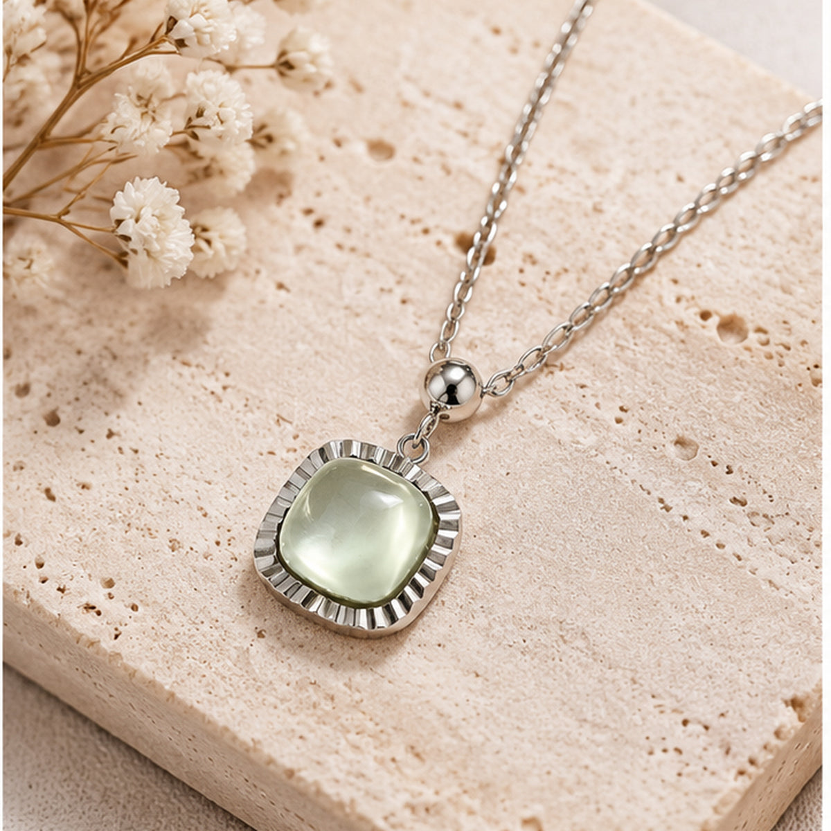 NZGO Pearl pale green cushion pendant necklace in a neutral studio setting
