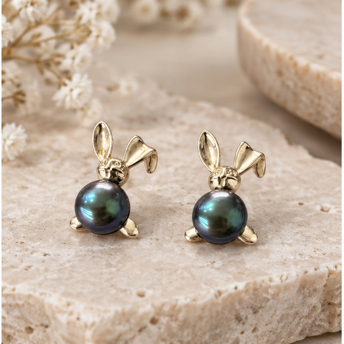 NZGO Pearl real pearl bunny stud earrings styled on neutral stone