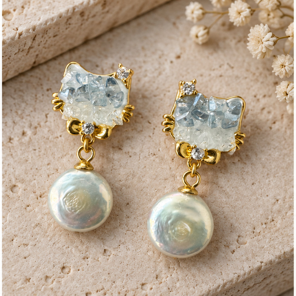 NZGO Pearl real pearl cat drop earrings styled on neutral stone