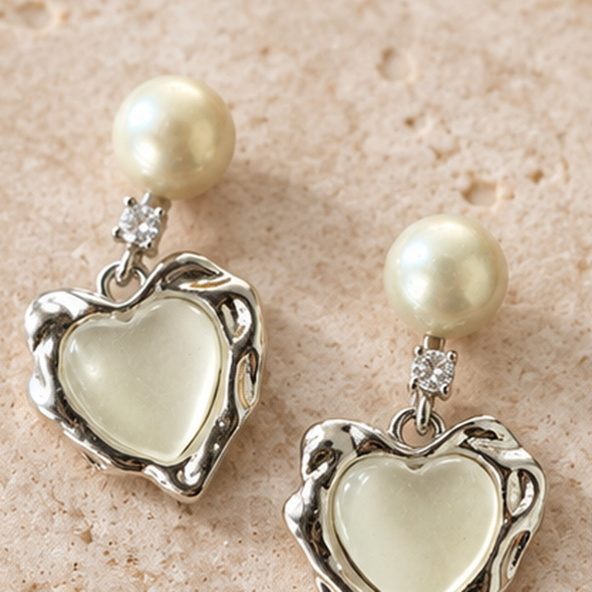 NZGO Pearl real pearl heart drop earrings styled on neutral stone