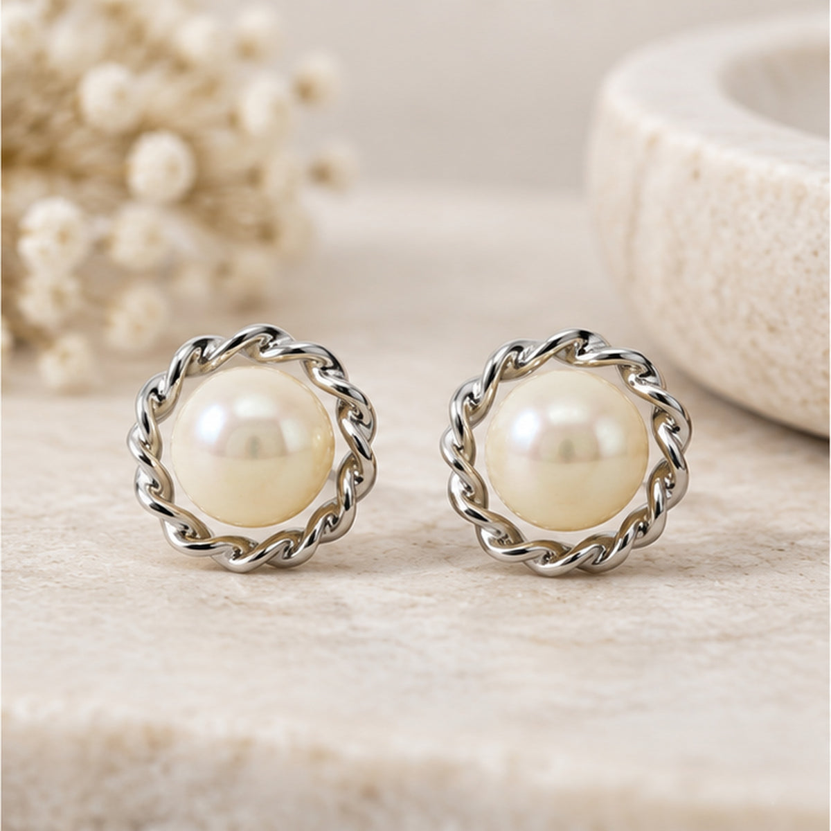 NZGO Pearl real pearl twisted halo stud earrings in a neutral studio setting