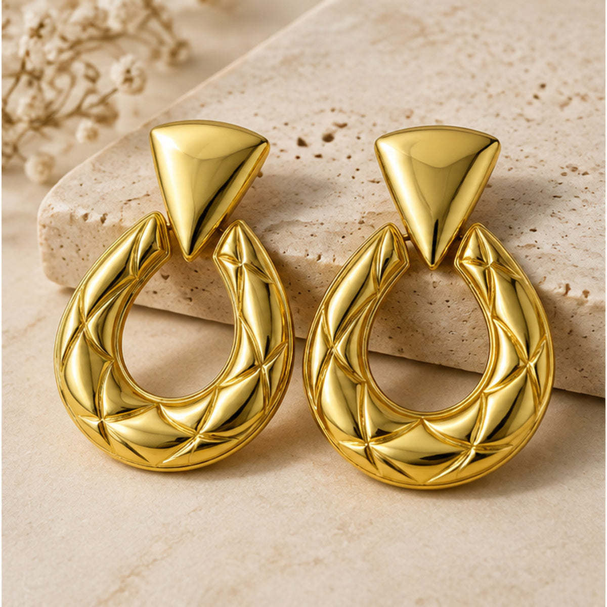 NZGO Pearl sculptural horseshoe statement earrings in a neutral studio setting