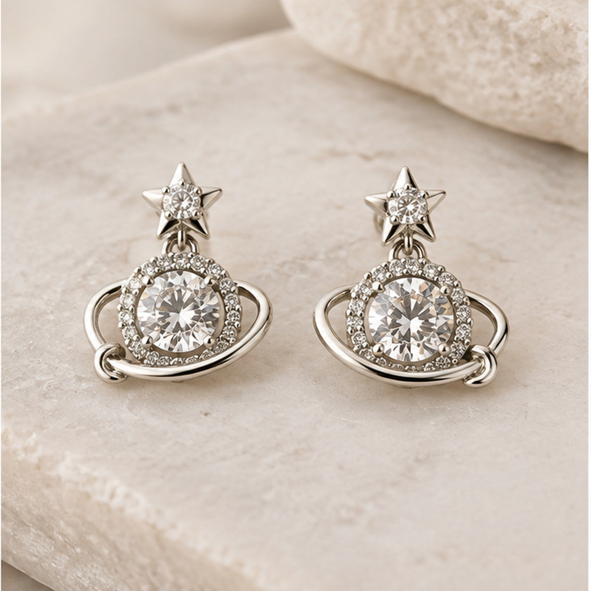 NZGO Pearl star orbit crystal drop earrings in a neutral studio setting