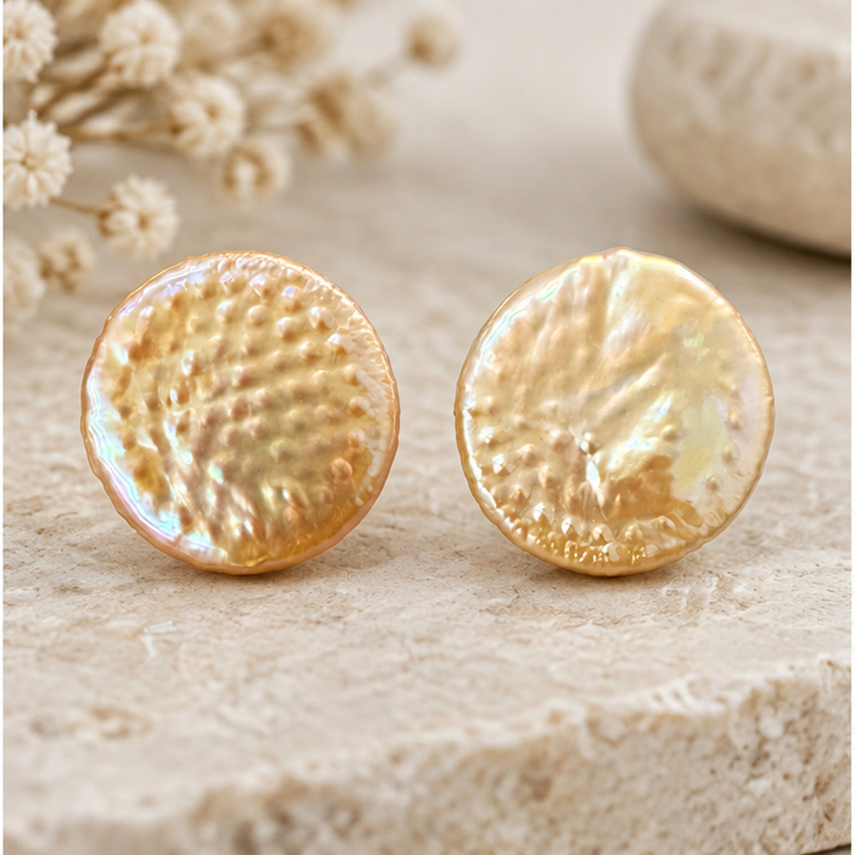 NZGO Pearl textured coin pearl stud earrings in a neutral studio setting