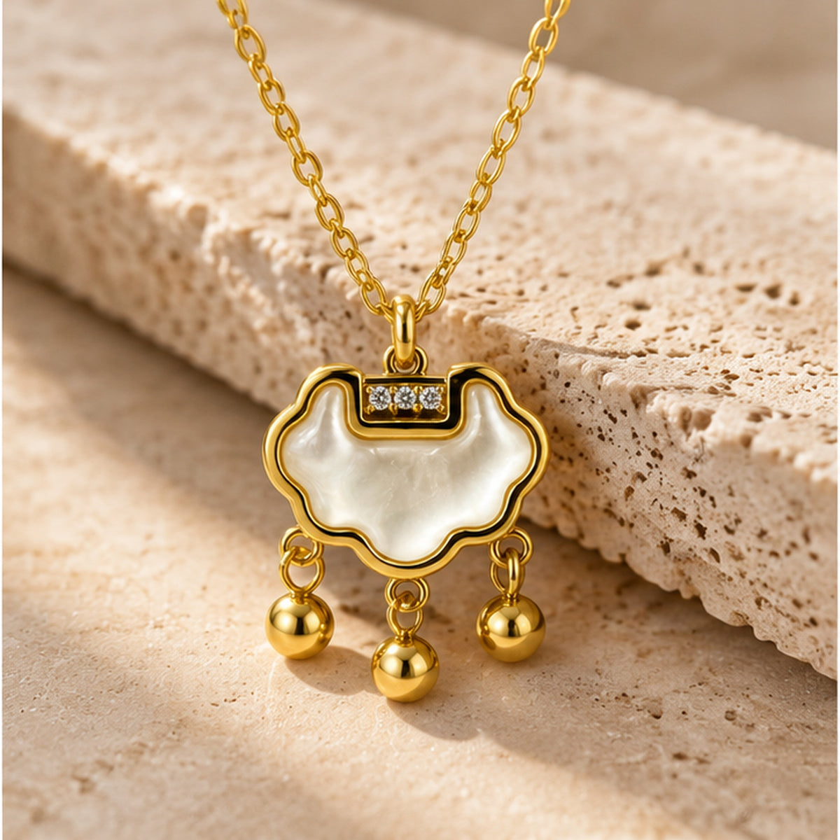 NZGO Pearl three-drop cloud pendant necklace in a neutral studio setting