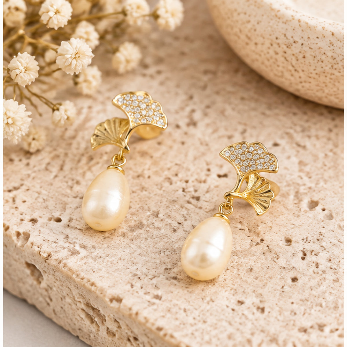 Ginkgo leaf real pearl drop earrings in a neutral jewellery studio setting