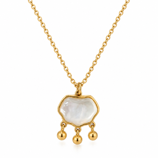 Gold-tone mother-of-pearl pendant necklace with three dangling bead charms on white background