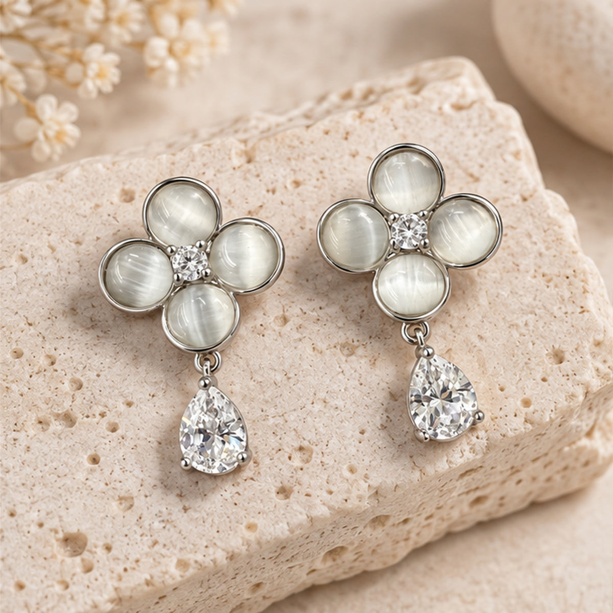 Mother-of-pearl flower crystal drop earrings in a neutral studio setting