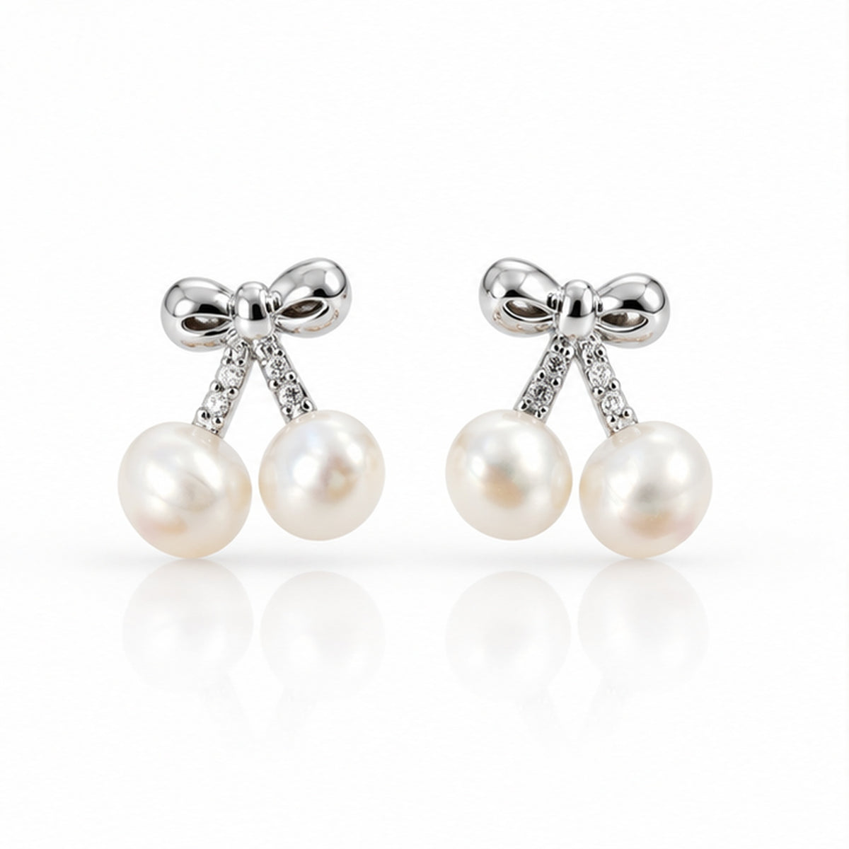 Real pearl bow double drop stud earrings on a clean white background