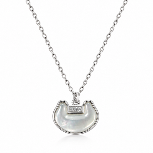 Silver-tone mother-of-pearl crescent pendant necklace with crystal accent on white background
