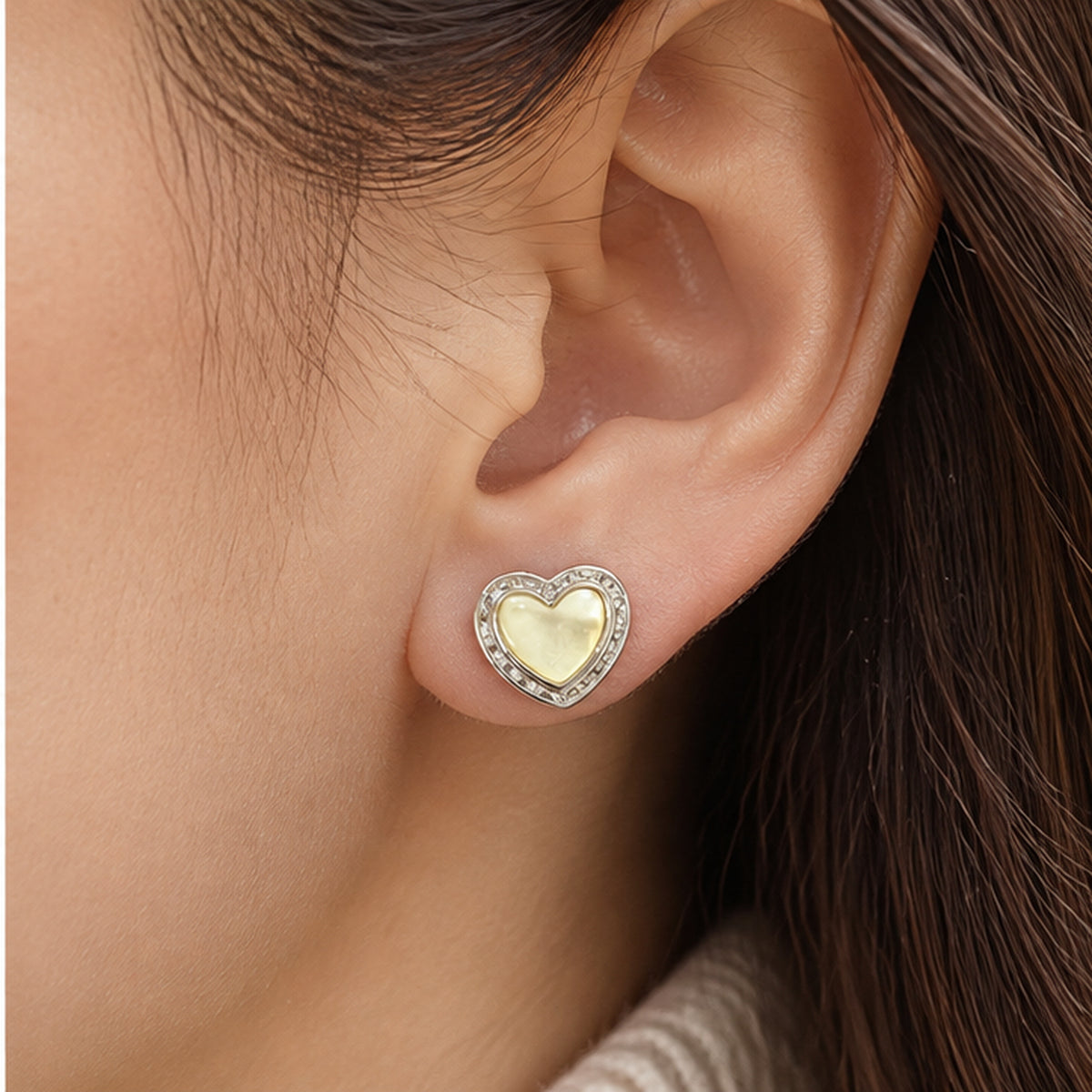 Mother of pearl heart stud earring with solid sterling silver post shown worn at realistic scale