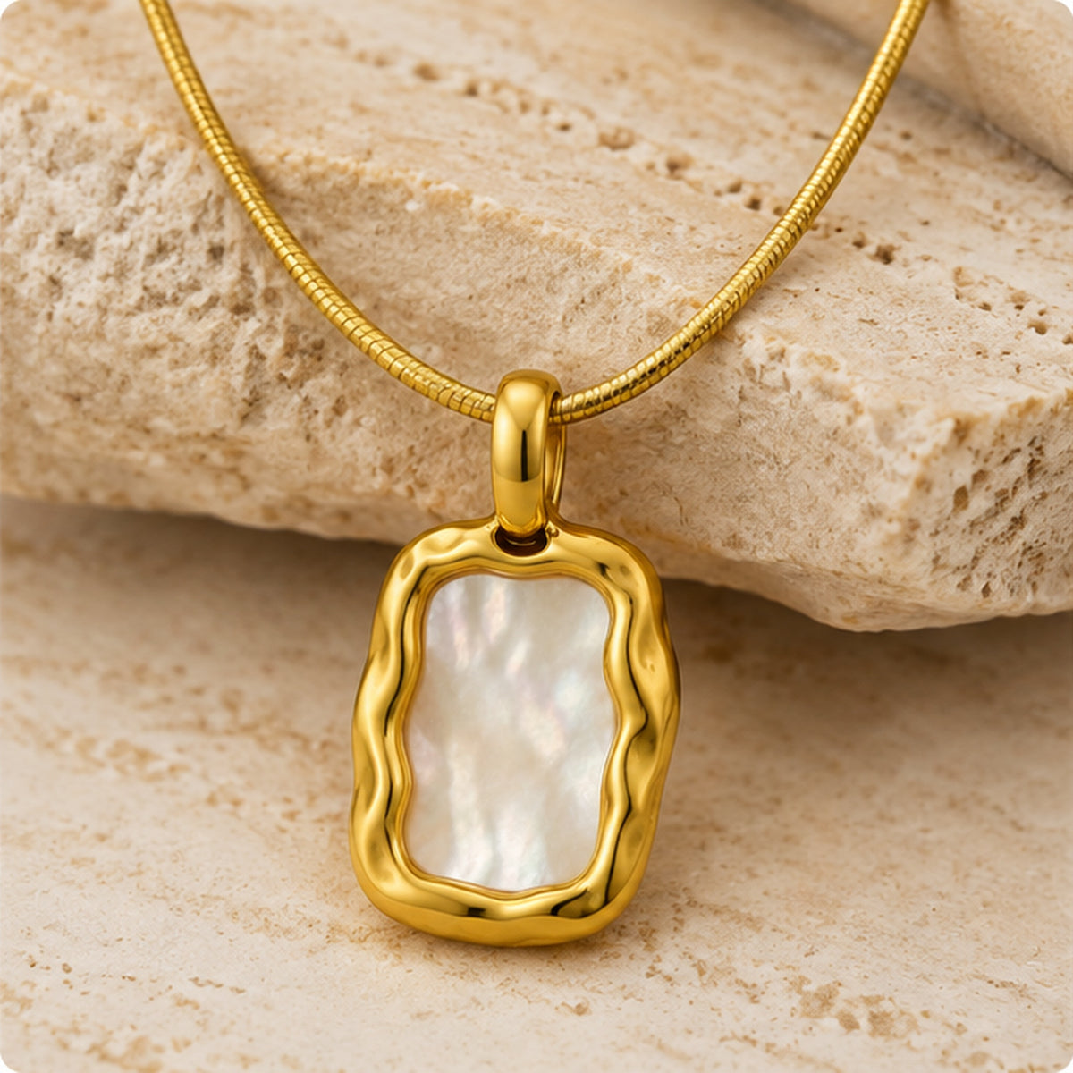 Organic mother of pearl rectangle pendant necklace in gold styled on neutral stone